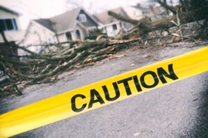 A section of caution tape is visible on the street outside a house marking off an area for safety reasons