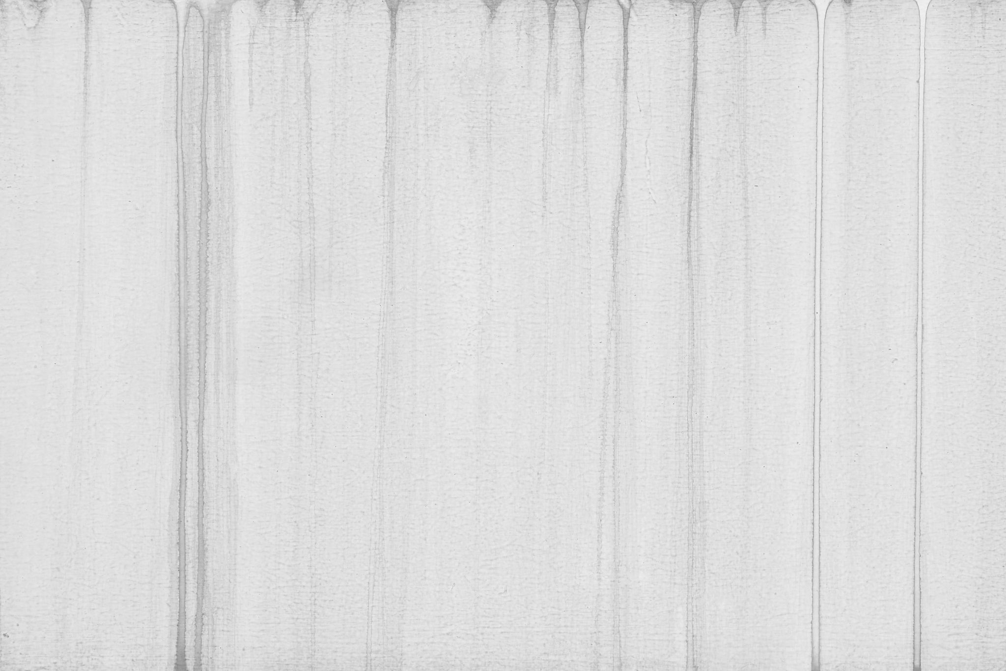 Clean, vertical water runoff streaks on a light gray painted or plastered wall.