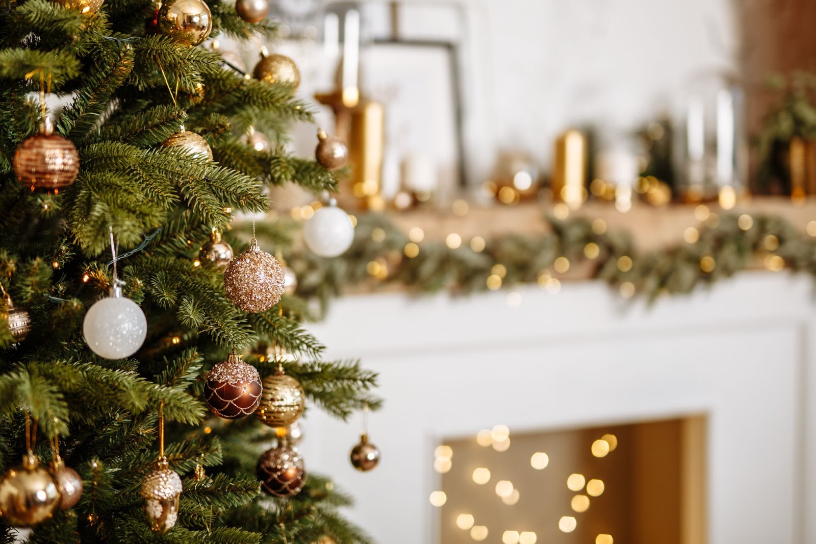 A Christmas tree embellished with gold ornaments is set near a fireplace, showcasing the joy of the season while reminding of fire hazards.