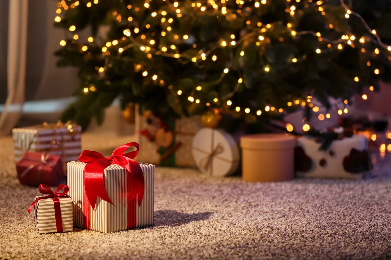 A decorated Christmas tree stands tall, surrounded by colorful presents, highlighting festive holiday cheer and safety awareness.