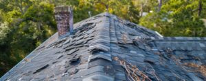 Workers repairing a residential roof in Charleston, SC with tools visible
