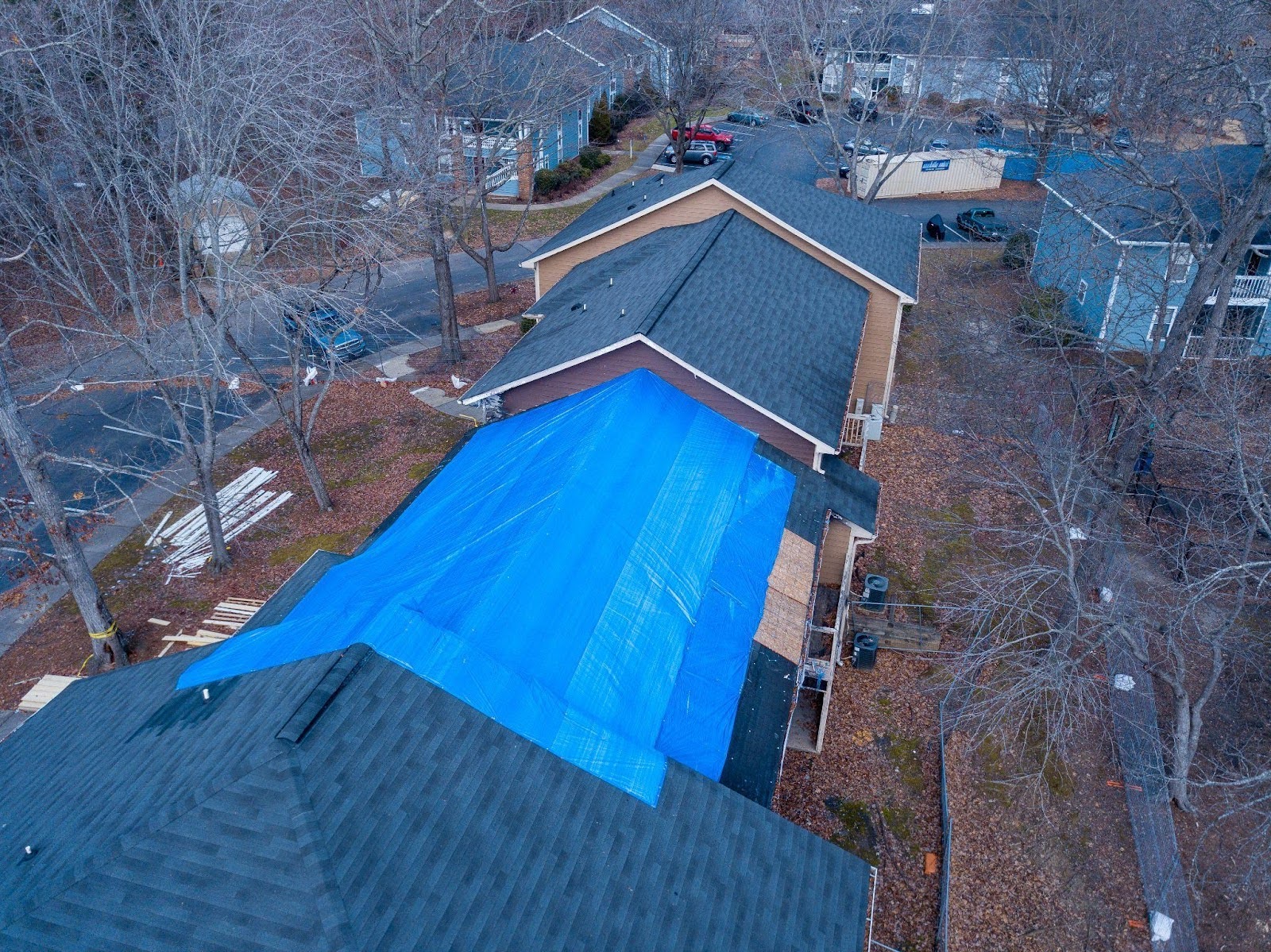 Bird-eye view of a roof with a blue tarp likely used for temporary protection or repair work
