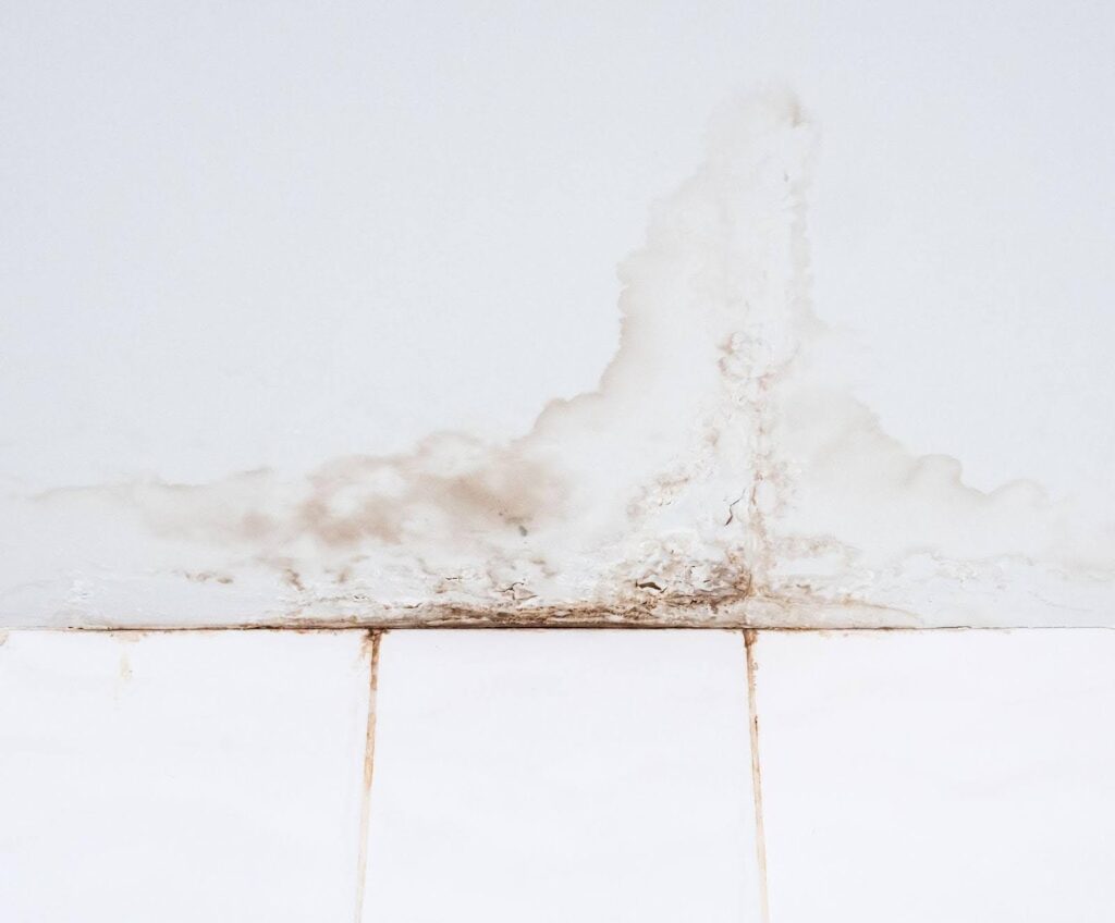 A white wall marred by a noticeable brown stain suggesting potential wear or a spill