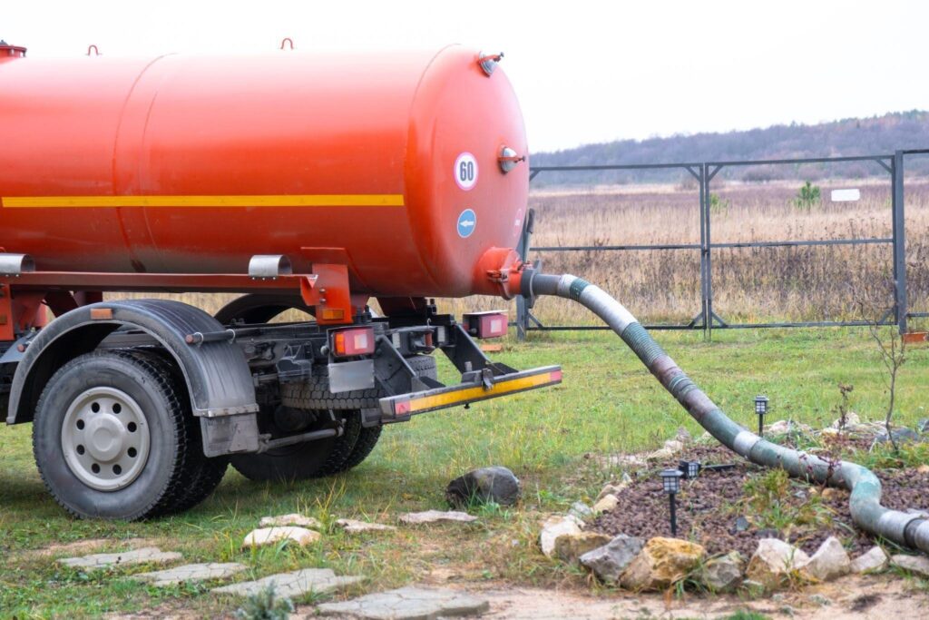 A large orange tank mounted on a truck showcasing its industrial design and transportation capability